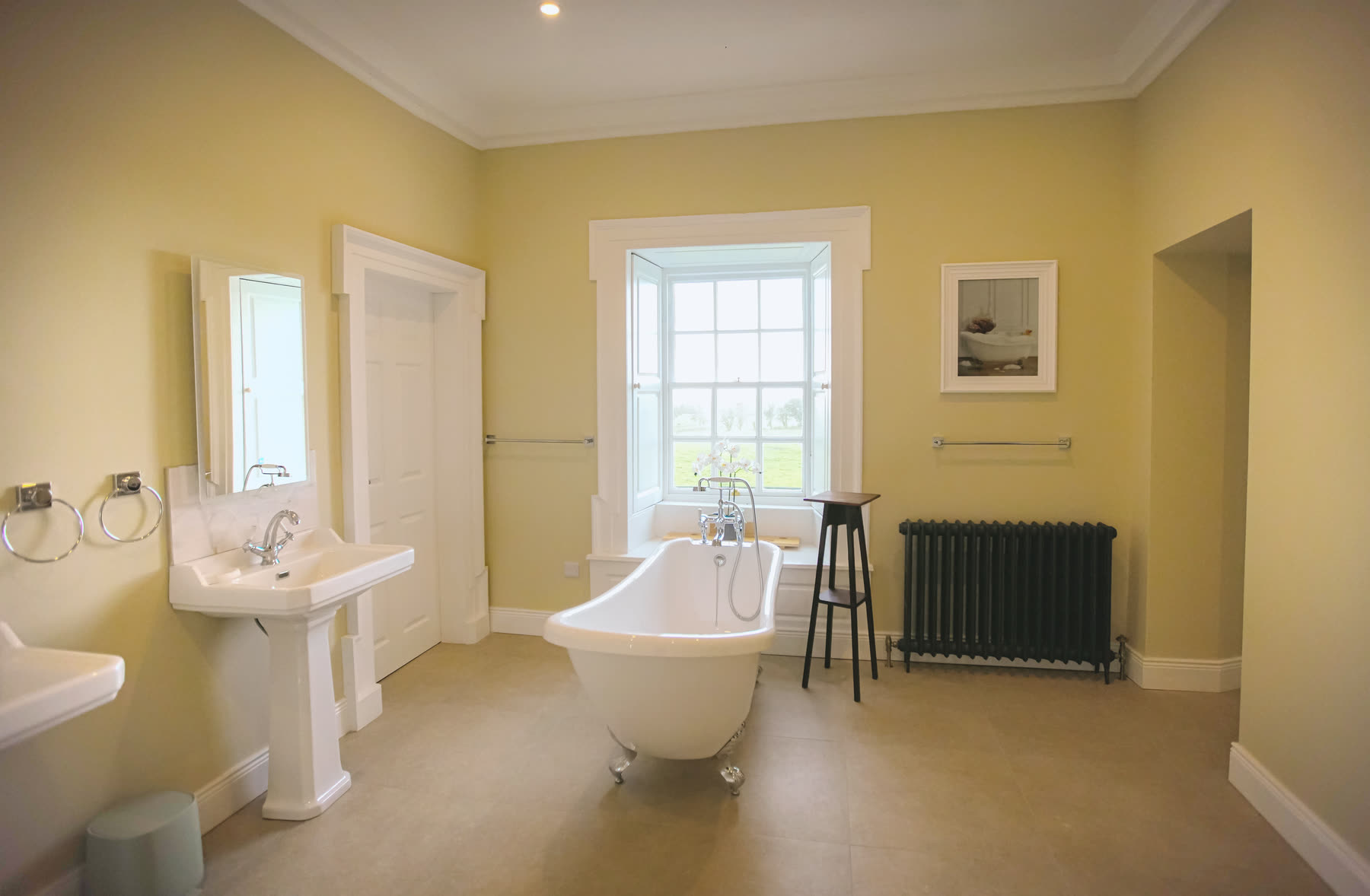 A roll-top bath with estate views